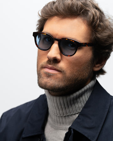 Milo Havana round sunglasses blue lenses man wearing 